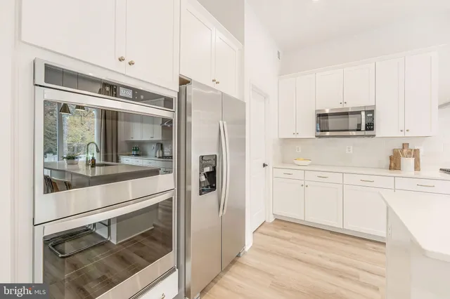a living room with furniture a fireplace and a large window