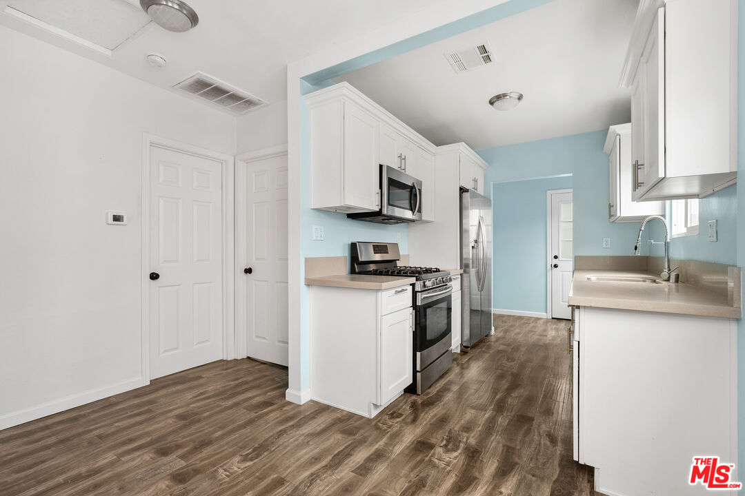 2738 Cloverdale Avenue Los Angeles, CA 90016 - Photo 11 of 17 a kitchen with granite countertop a sink and a stove top oven