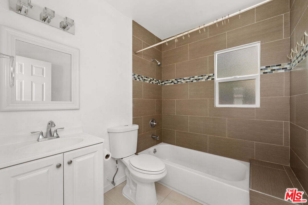 2738 Cloverdale Avenue Los Angeles, CA 90016 - Photo 17 of 17 a bathroom with a sink a toilet and shower