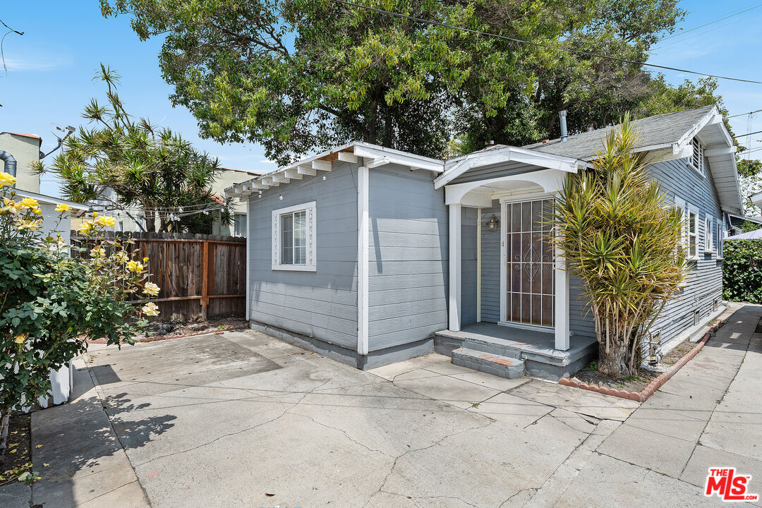 2738 Cloverdale Avenue Los Angeles, CA 90016 - Photo 2 of 17 a view of a small house with plants and large tree