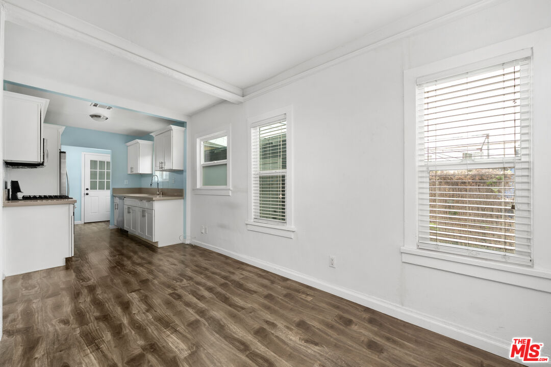2738 Cloverdale Avenue Los Angeles, CA 90016 - Photo 10 of 17 a view of a kitchen with wooden floor and windows
