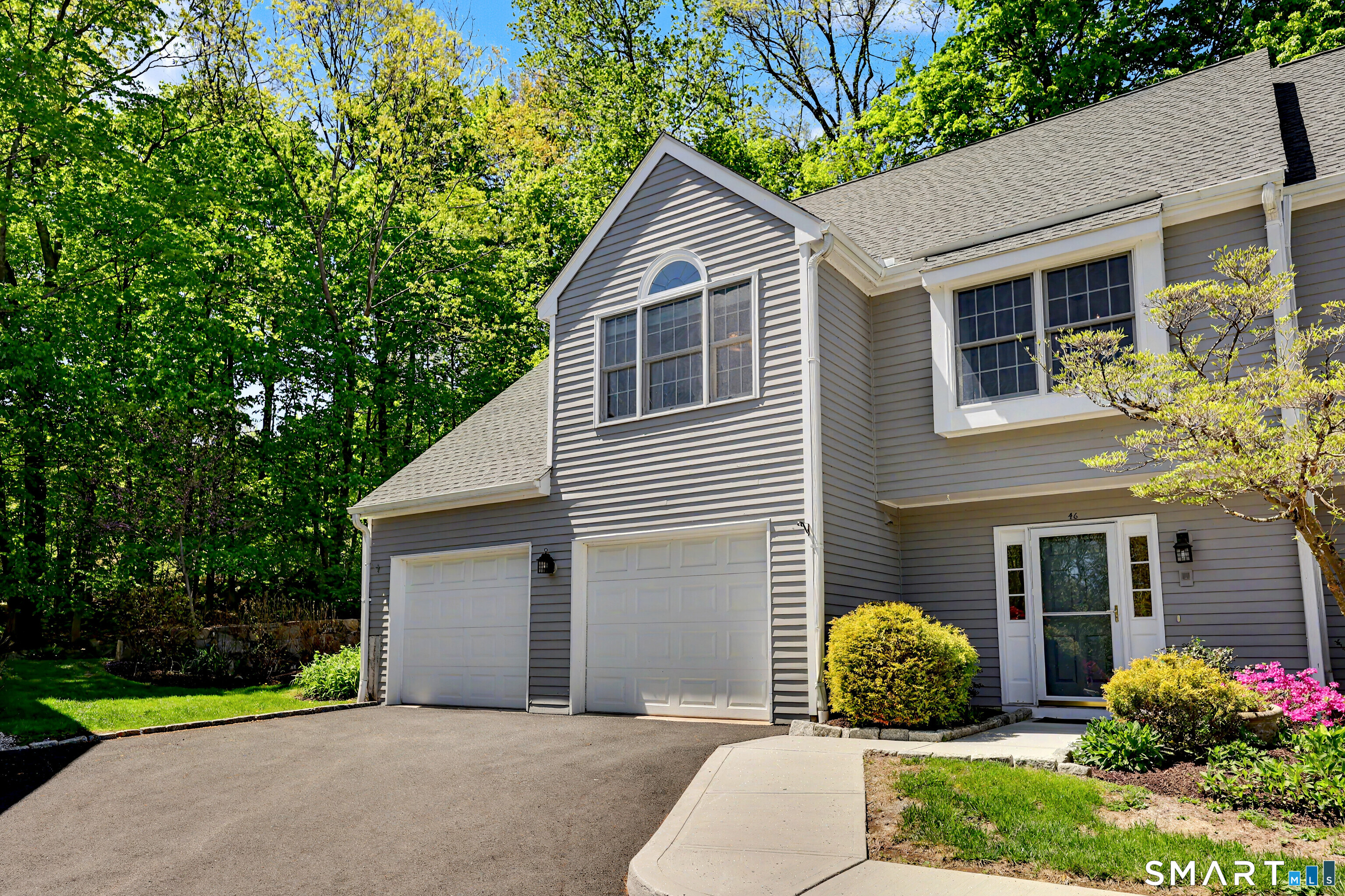 120 Prospect Street, Unit 46 Ridgefield, CT 06877 - Photo 1 of 36 a front view of a house with garden and plants