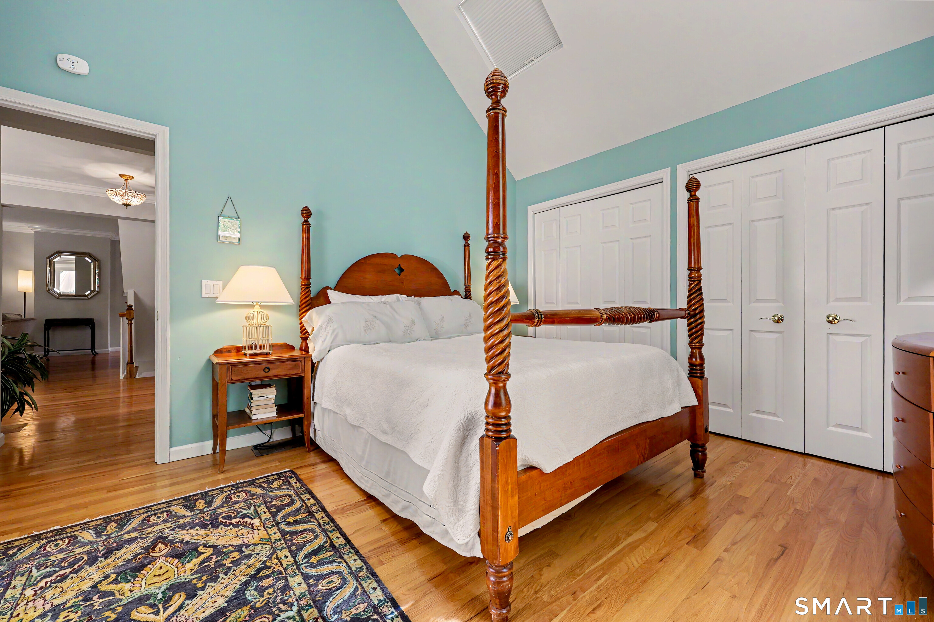 120 Prospect Street, Unit 46 Ridgefield, CT 06877 - Photo 19 of 36 a bedroom with a bed and wooden floor