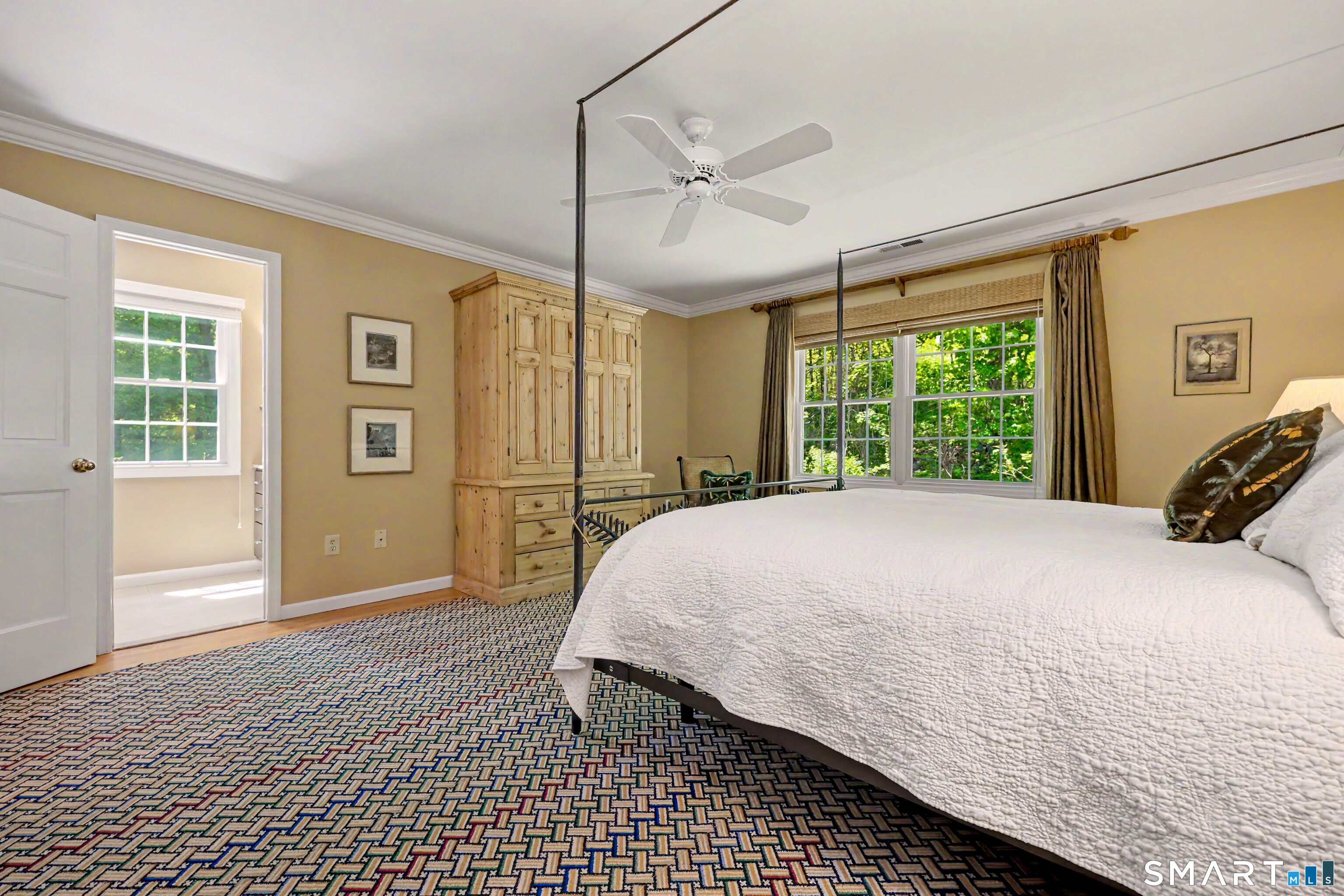 120 Prospect Street, Unit 46 Ridgefield, CT 06877 - Photo 25 of 36 a bedroom with a large bed a chandelier and windows