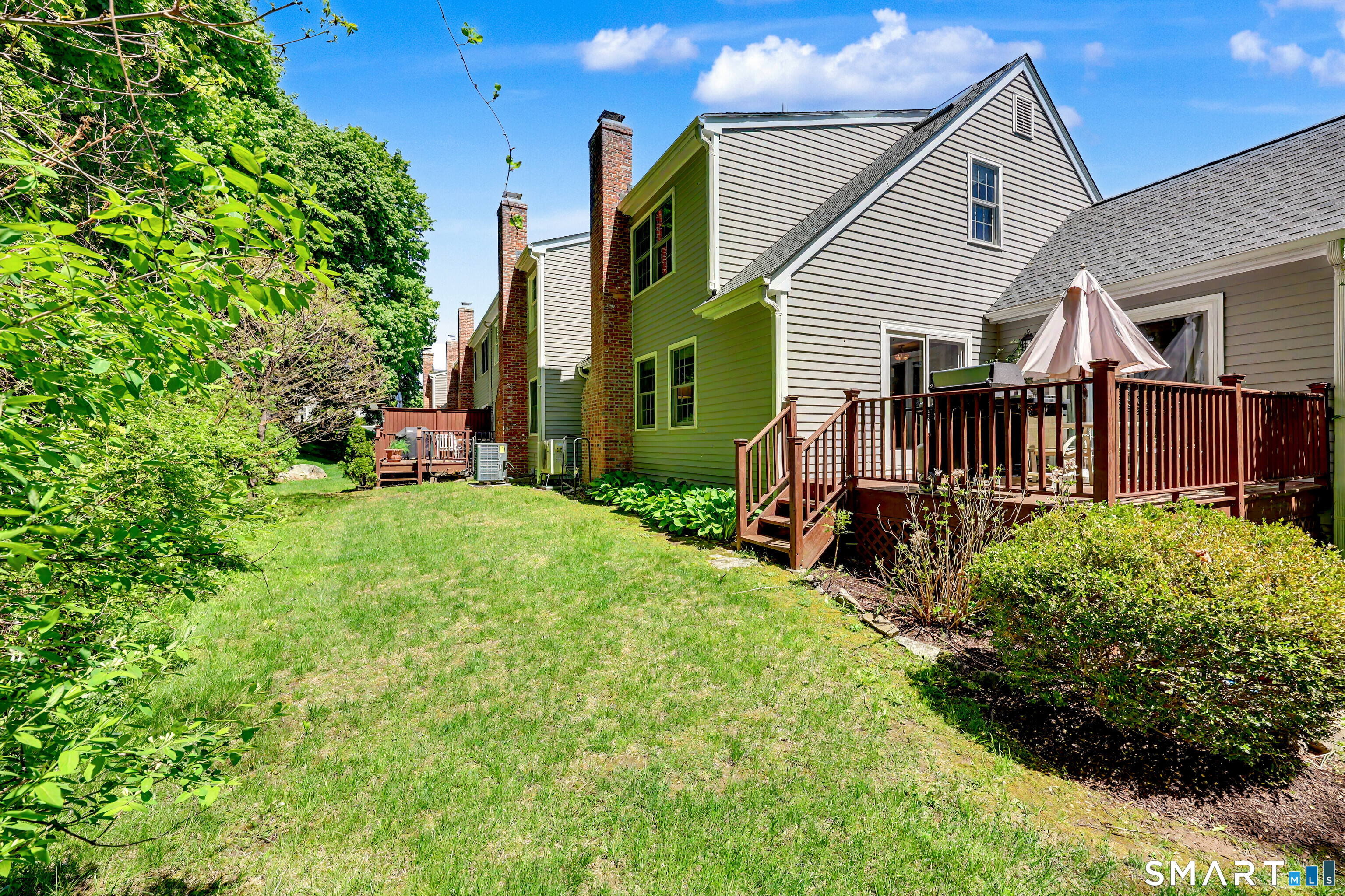 120 Prospect Street, Unit 46 Ridgefield, CT 06877 - Photo 30 of 36 a view of a house with a yard and flower plants