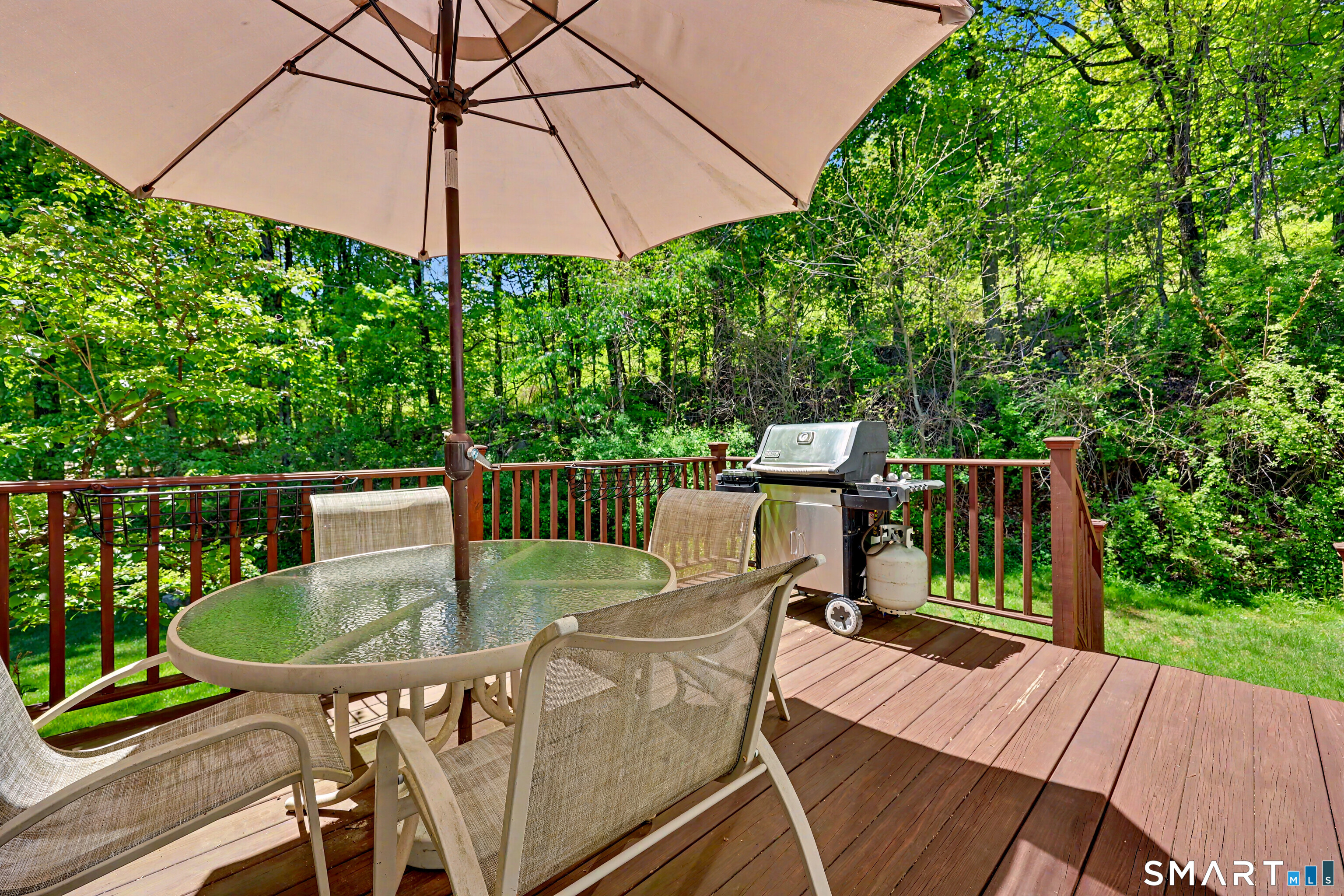 120 Prospect Street, Unit 46 Ridgefield, CT 06877 - Photo 3 of 36 a balcony with a table and chairs under an umbrella