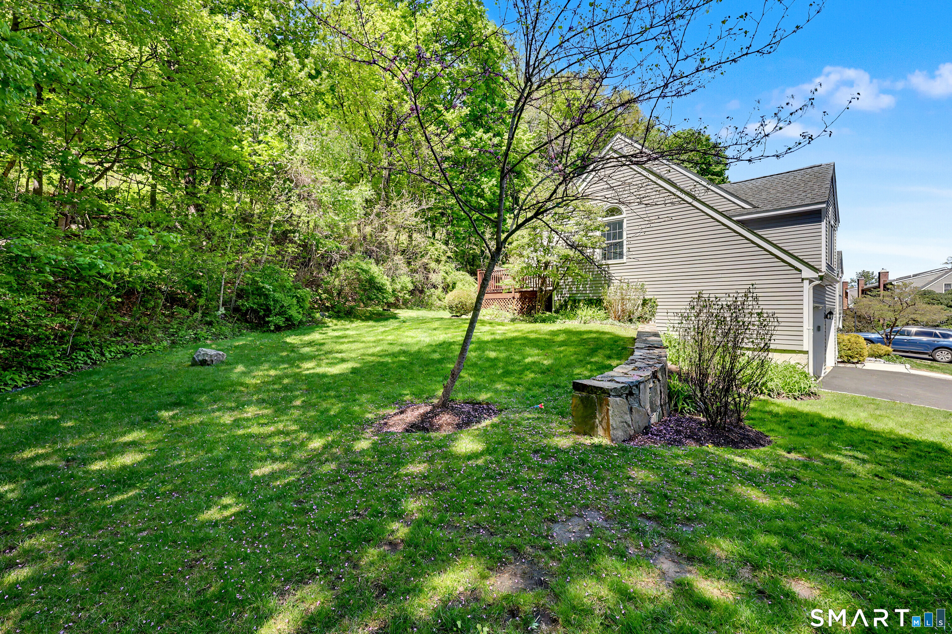 120 Prospect Street, Unit 46 Ridgefield, CT 06877 - Photo 33 of 36 a view of a chair and table in backyard of the house