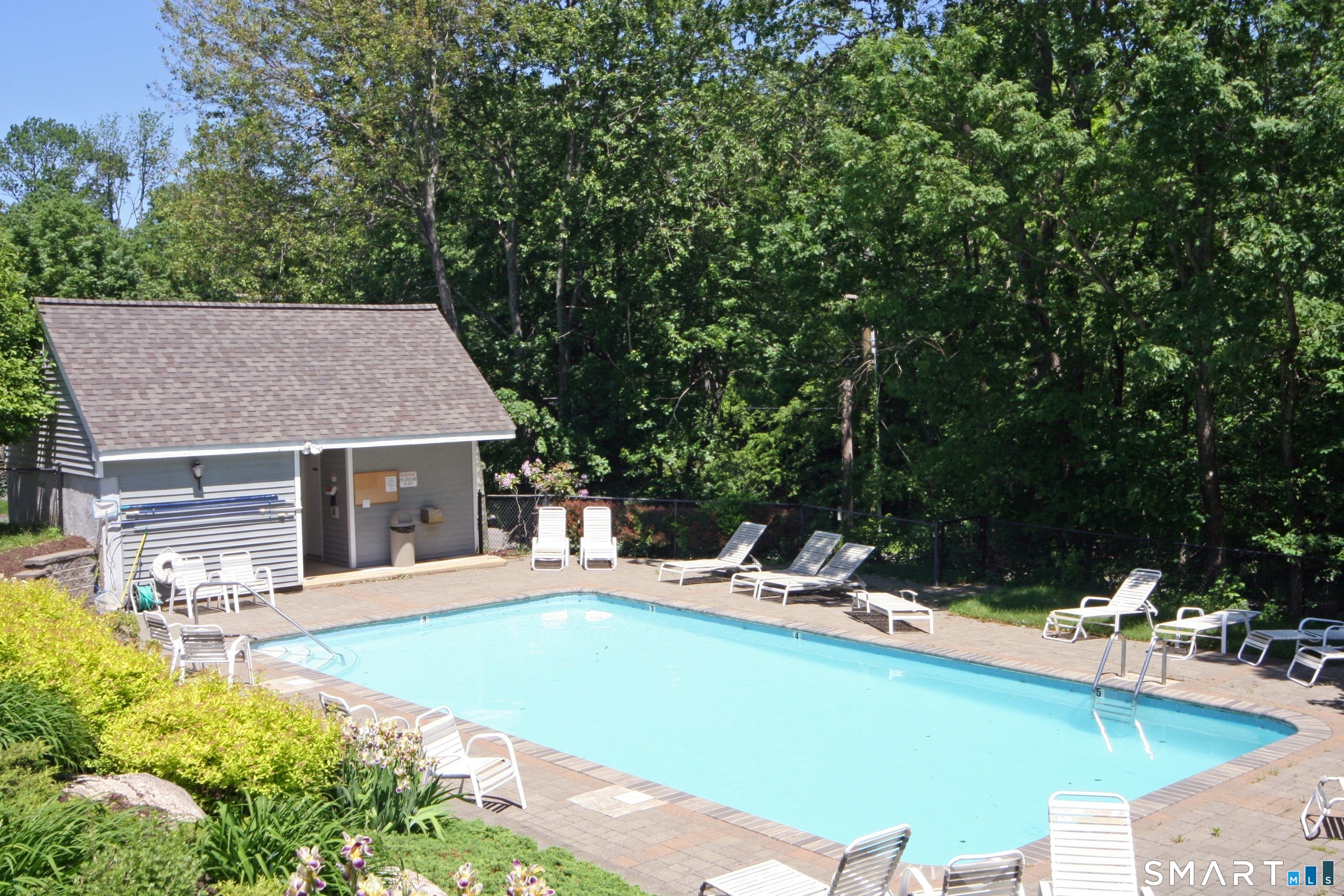 120 Prospect Street, Unit 46 Ridgefield, CT 06877 - Photo 35 of 36 a view of a house with pool and chairs
