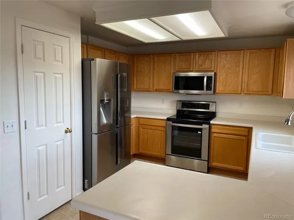 a kitchen with a refrigerator stove and microwave