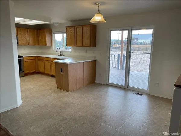 a kitchen with stainless steel appliances granite countertop a sink a stove and a refrigerator