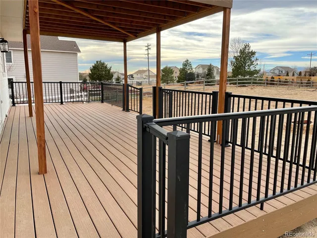 a view of a balcony with wooden floor