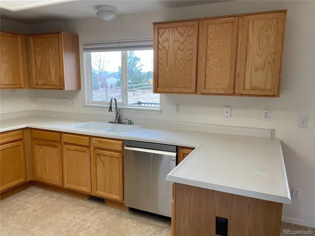 a kitchen with stainless steel appliances granite countertop a sink a stove and a microwave