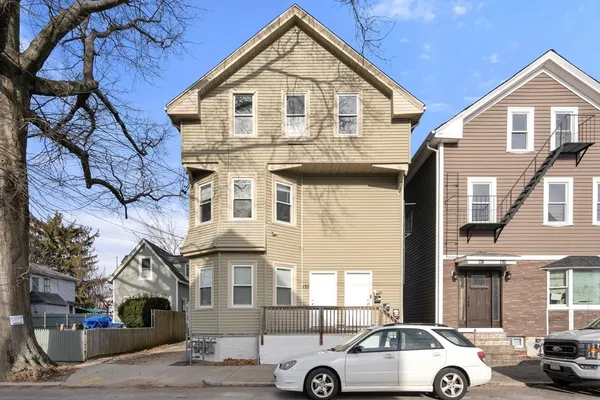 a front view of a house with parking