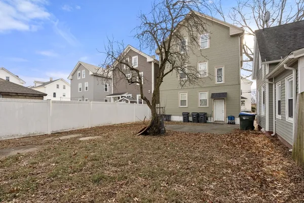 a view of a grey house with a snow