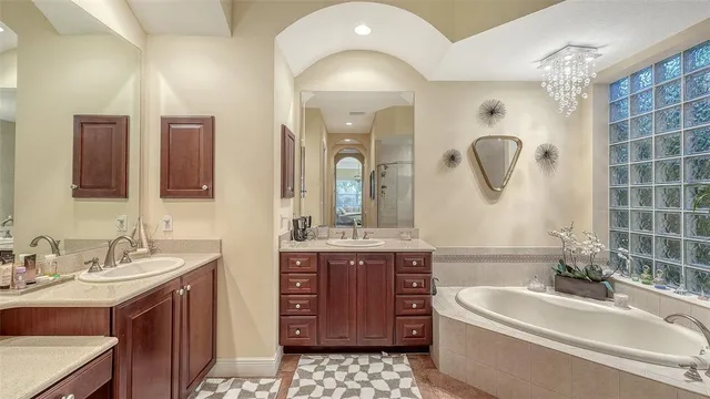 a bedroom with a large bed and a painting on the wall