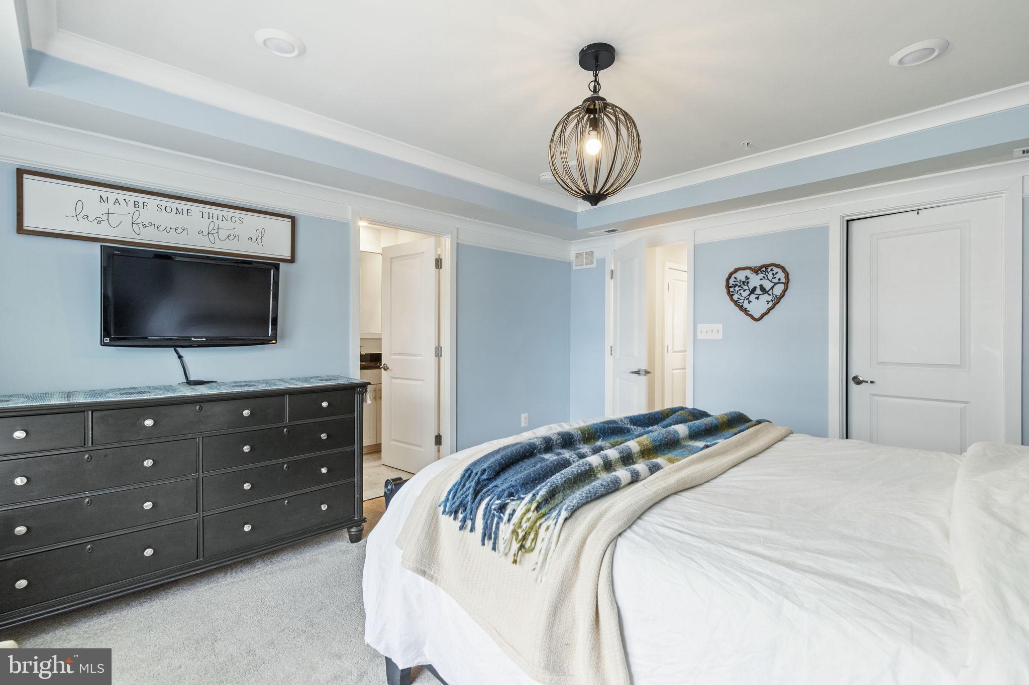 2045 Ivory Brook Road Baltimore, MD 21244 - Photo 18 of 39 a bedroom with a bed and a flat screen tv