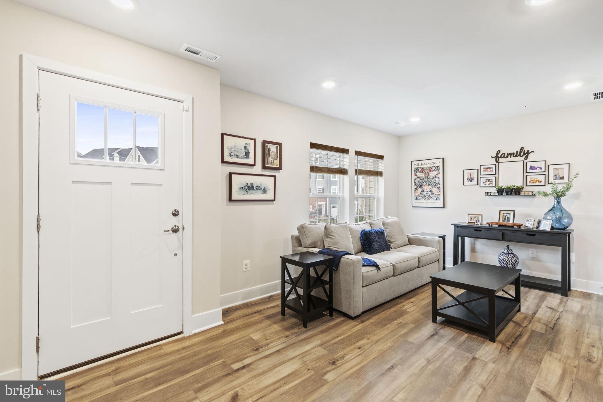 2045 Ivory Brook Road Baltimore, MD 21244 - Photo 2 of 39 a living room with furniture and wooden floor