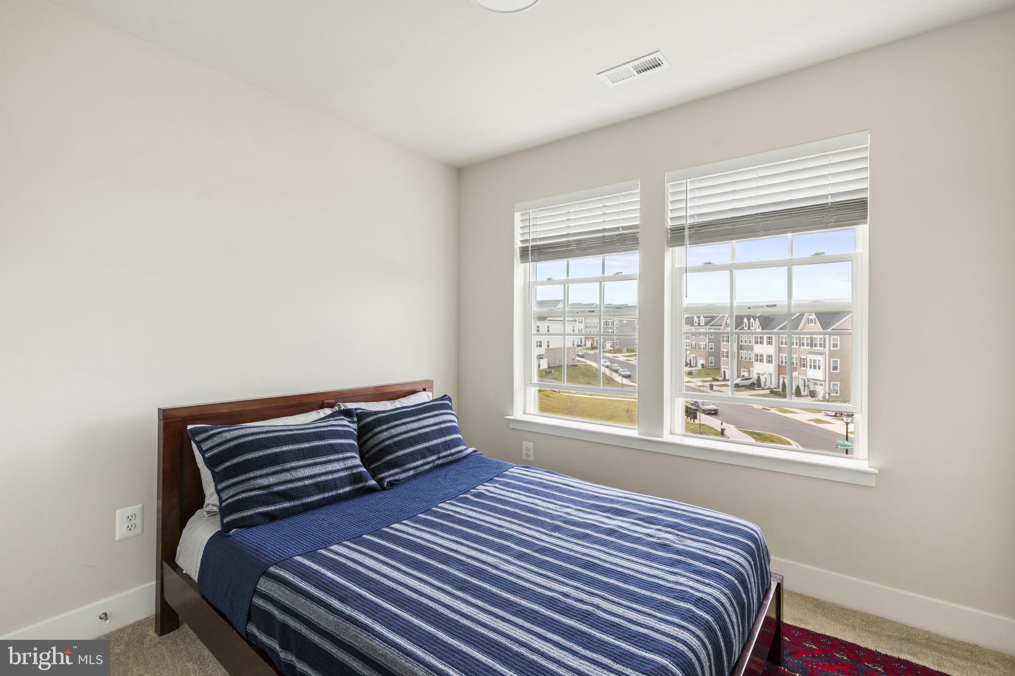 2045 Ivory Brook Road Baltimore, MD 21244 - Photo 24 of 39 a bedroom with a bed and wooden floor