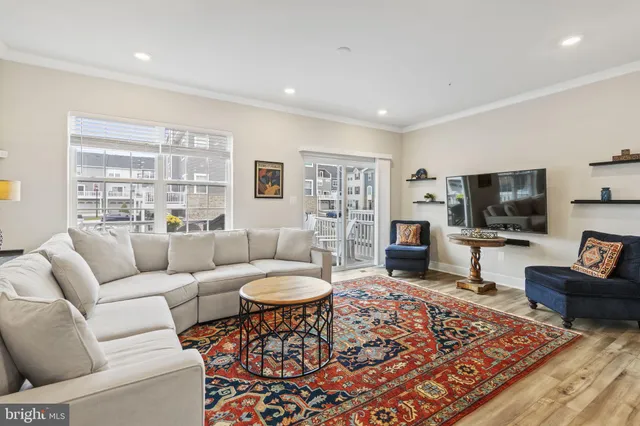 a living room with furniture a rug and a flat screen tv