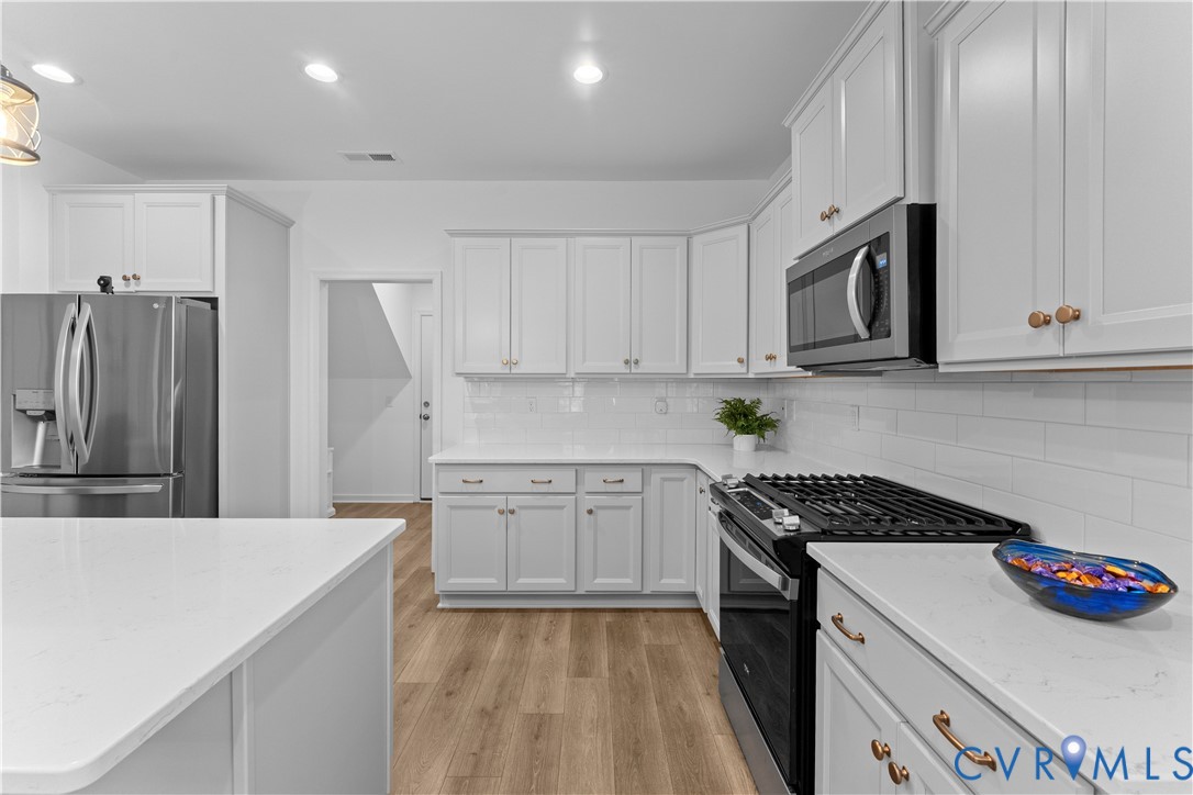 8819 Roberta Road Mechanicsville, VA 23116 - Photo 32 of 79 White cabinetry with gold-tone hardware, wood-fini