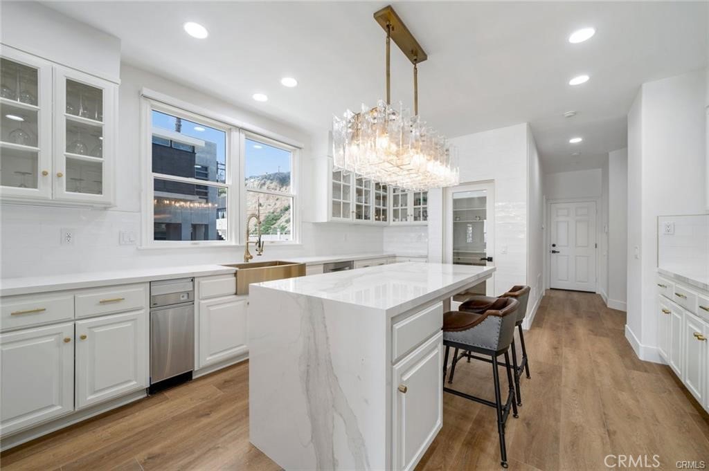 35555 Beach Road Dana Point, CA 92624 - Photo 19 of 68 a kitchen with stainless steel appliances granite countertop a stove and a wooden floors