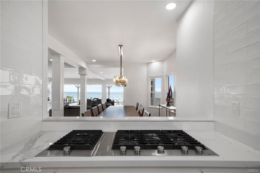 35555 Beach Road Dana Point, CA 92624 - Photo 20 of 68 a kitchen with a stove and white cabinets