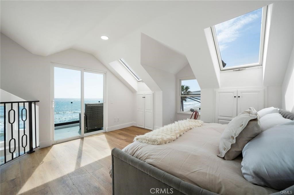 35555 Beach Road Dana Point, CA 92624 - Photo 25 of 68 a bedroom with a large bed and a chandelier