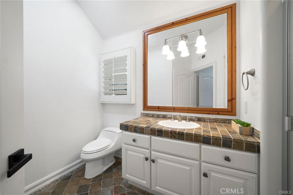 35555 Beach Road Dana Point, CA 92624 - Photo 32 of 68 a bathroom with a granite countertop sink mirror vanity and toilet