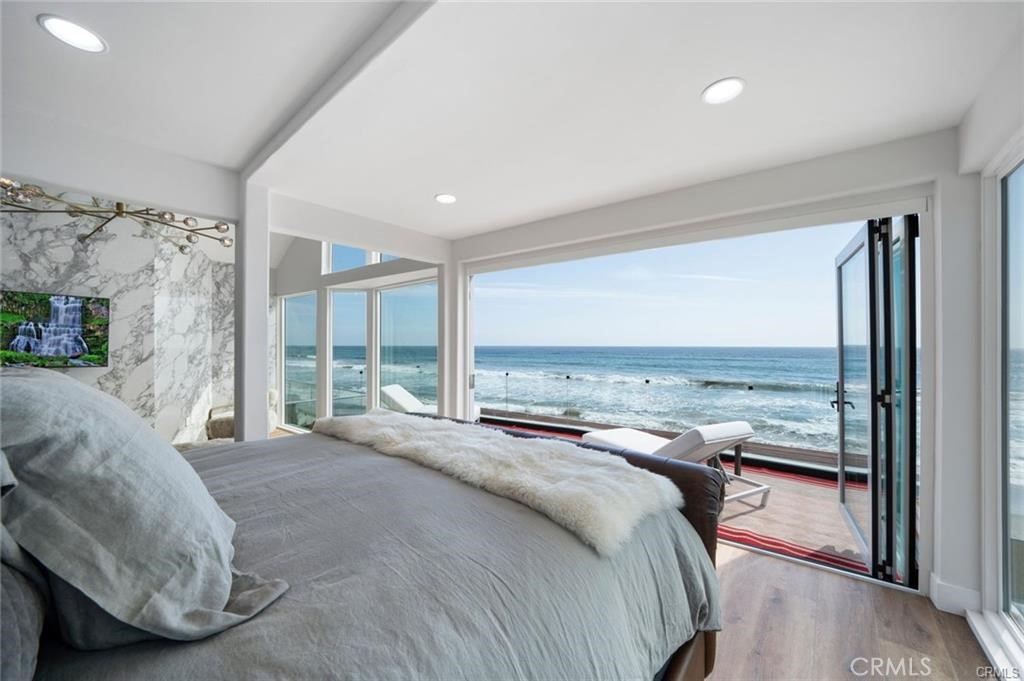 35555 Beach Road Dana Point, CA 92624 - Photo 38 of 68 a bedroom with a bed and glass walk in closet