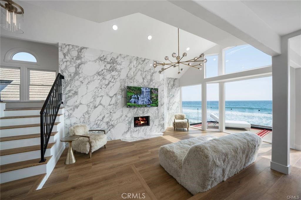 35555 Beach Road Dana Point, CA 92624 - Photo 39 of 68 a spacious bedroom with a large bed and a chandelier