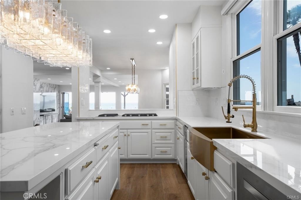 35555 Beach Road Dana Point, CA 92624 - Photo 51 of 68 a large kitchen with granite countertop a large counter top a sink stainless steel appliances and cabinets