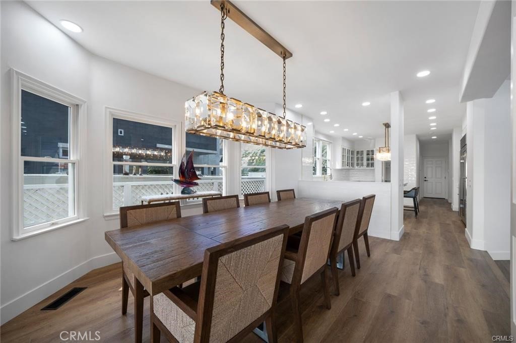 35555 Beach Road Dana Point, CA 92624 - Photo 52 of 68 a dining room with furniture a chandelier and wooden floor