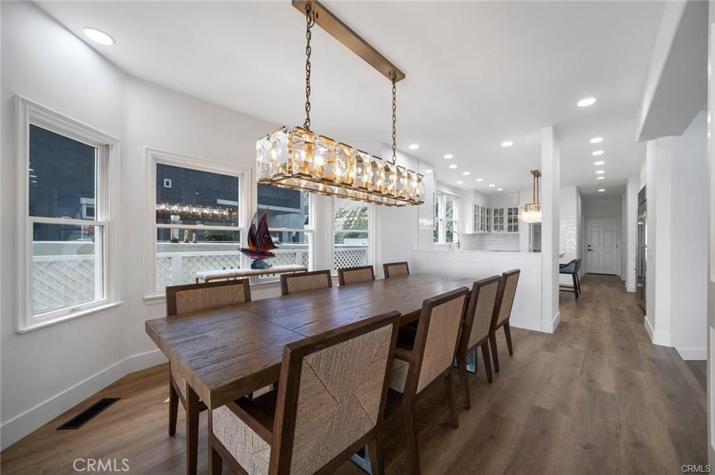 35555 Beach Road Dana Point, CA 92624 - Photo 54 of 68 a dining room with furniture a chandelier and wooden floor