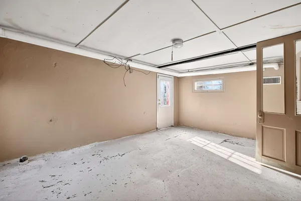 a big room with windows and chandelier