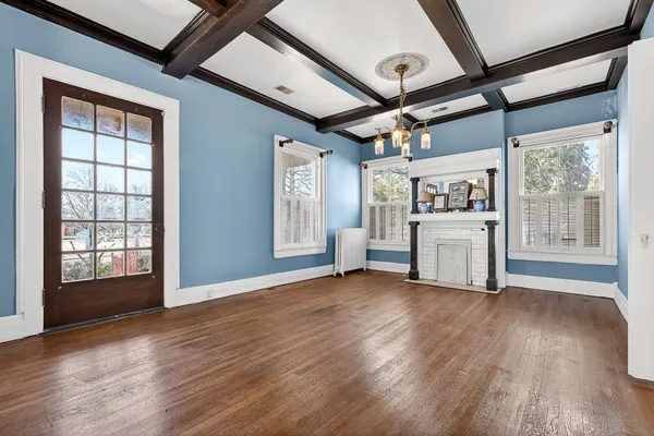 a view of hallway with wooden floor and stairs