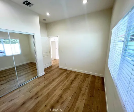 a view of an empty room and wooden floor