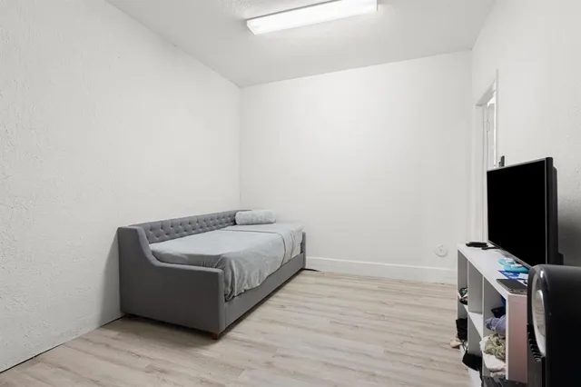 a room with a bed and a flat screen tv