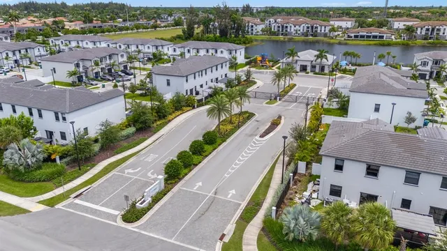 an aerial view of a house with a garden and lake view