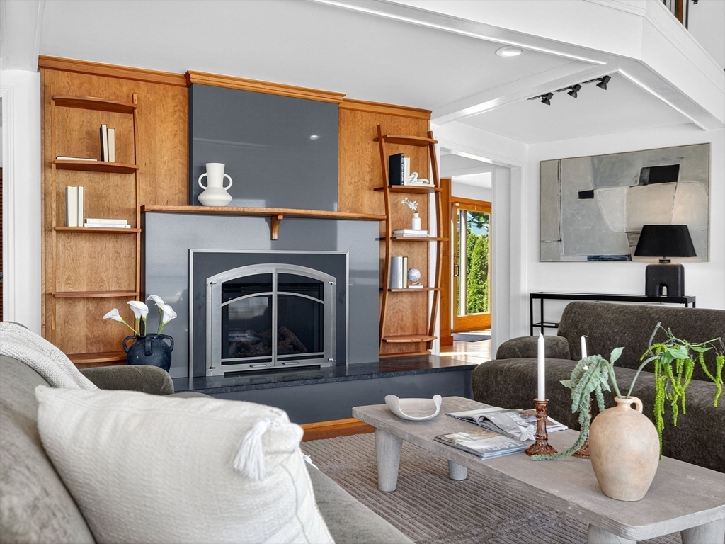 57 Harborview Road Hull, MA 02045 - Photo 11 of 41 a living room with furniture a potted plant and a fireplace