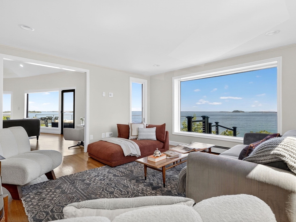 57 Harborview Road Hull, MA 02045 - Photo 16 of 41 a living room with furniture a rug a lamp and a large window