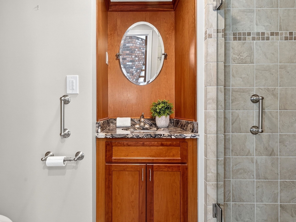 57 Harborview Road Hull, MA 02045 - Photo 18 of 41 a bathroom with a granite countertop sink a mirror and a shower