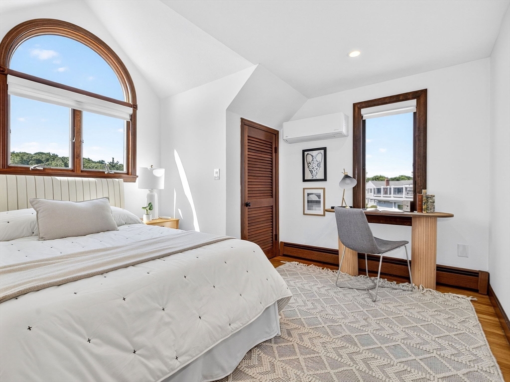 57 Harborview Road Hull, MA 02045 - Photo 22 of 41 a bedroom with a bed and a dresser with mirror