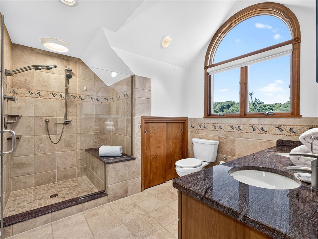 57 Harborview Road Hull, MA 02045 - Photo 27 of 41 a bathroom with a granite countertop sink a toilet a mirror and shower