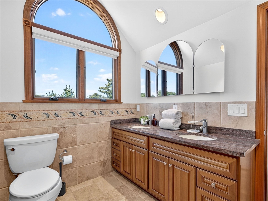 57 Harborview Road Hull, MA 02045 - Photo 28 of 41 a bathroom with a granite countertop toilet sink and mirror