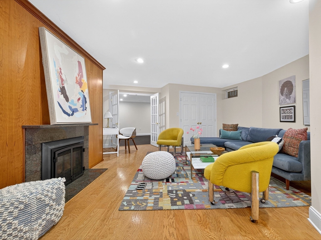 57 Harborview Road Hull, MA 02045 - Photo 29 of 41 a living room with furniture a fireplace and a flat screen tv