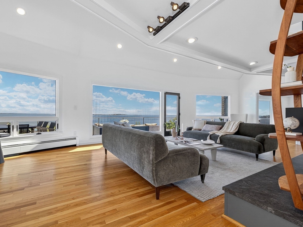 57 Harborview Road Hull, MA 02045 - Photo 9 of 41 a living room with furniture wooden floor and a large window