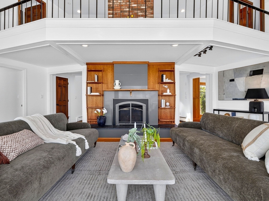57 Harborview Road Hull, MA 02045 - Photo 10 of 41 a living room with furniture and a fireplace