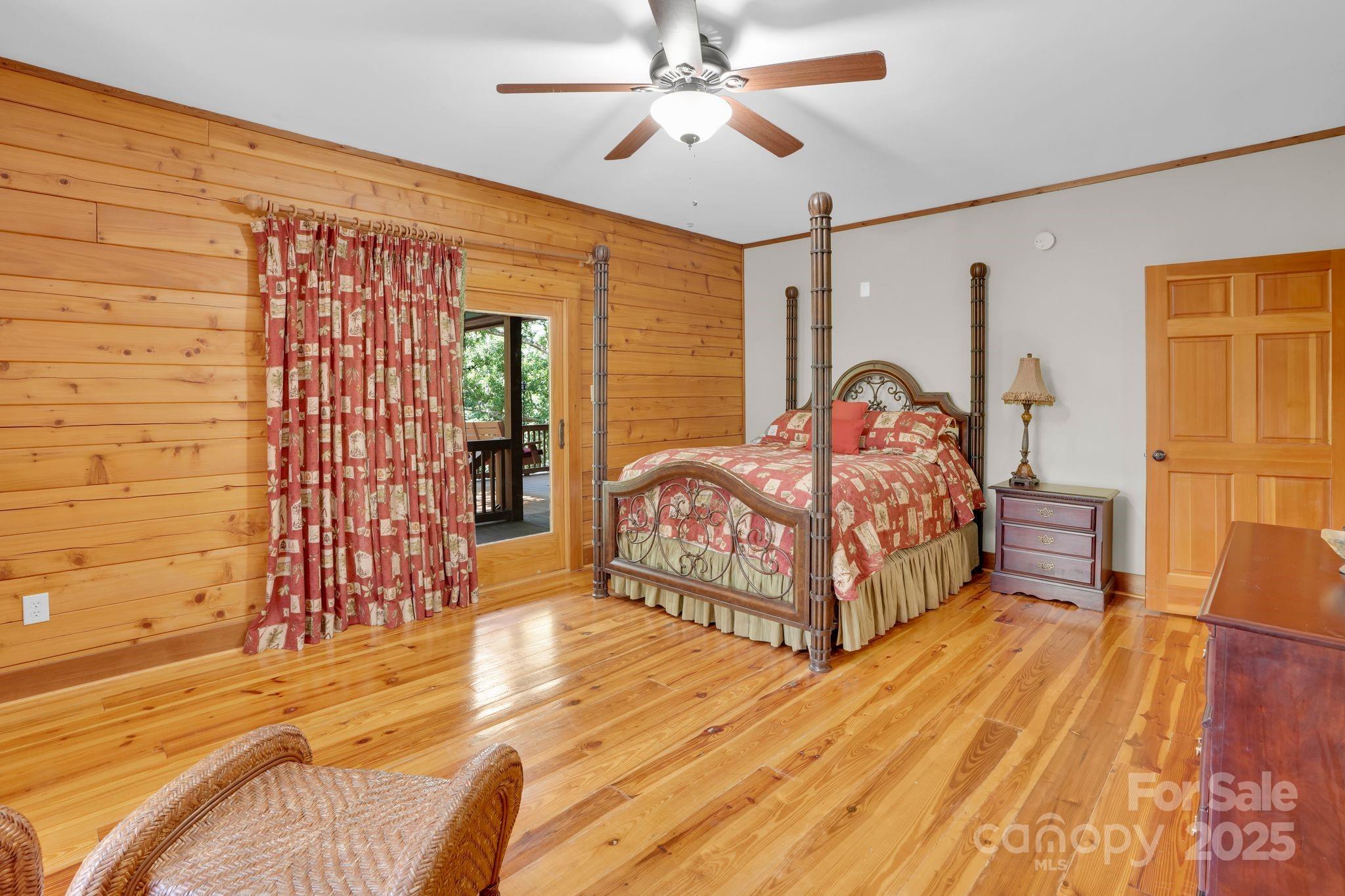 210 Big Rock Road Blacksburg, SC 29702 - Photo 21 of 46 a bedroom with a bed and a chandelier