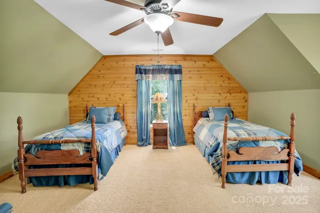 a bedroom with bed and a chandelier