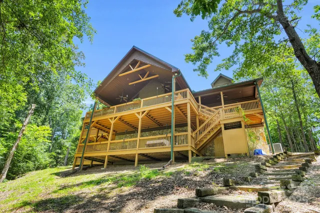 a view of a wooden house with a yard